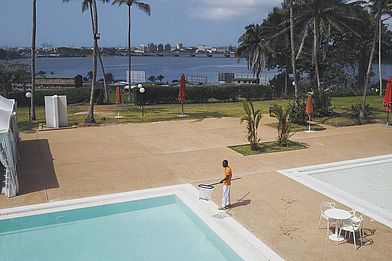 Ivory Coast. A hotel worker cleans a swimming pool in Abidjan.