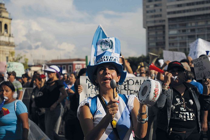The photo shows a female protester in Guatemala.
